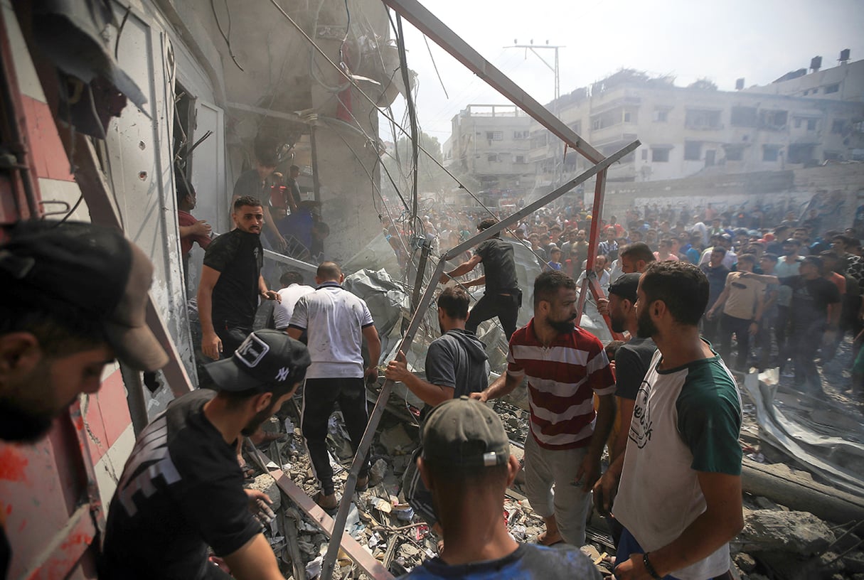 Le 9 octobre 2023, après un raid aérien israélien, des Palestiniens fouillent les ruines d’un immeuble à la recherche de survivants. © Mohamed Zaanoun/Middle East Images via AFP