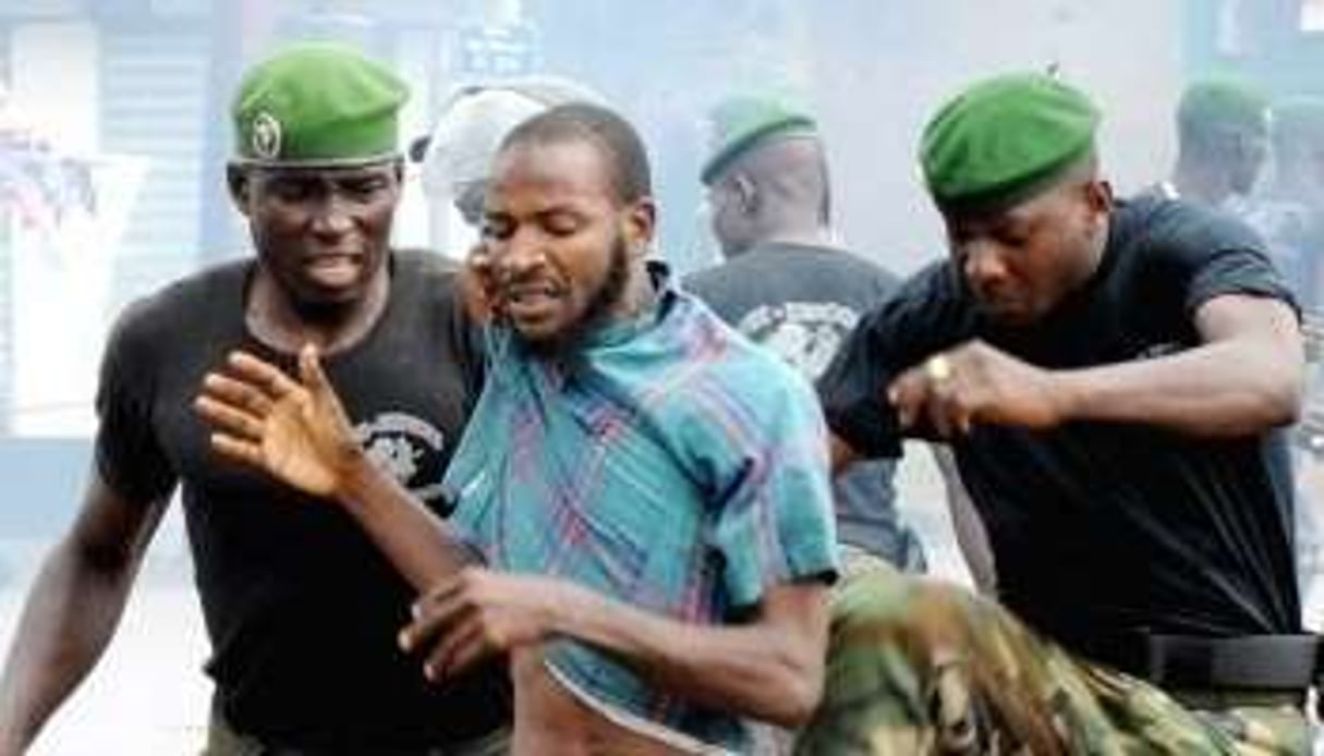 Policiers arrêtant un manifestant à Conakry le 28 septembre 2009 © AFP