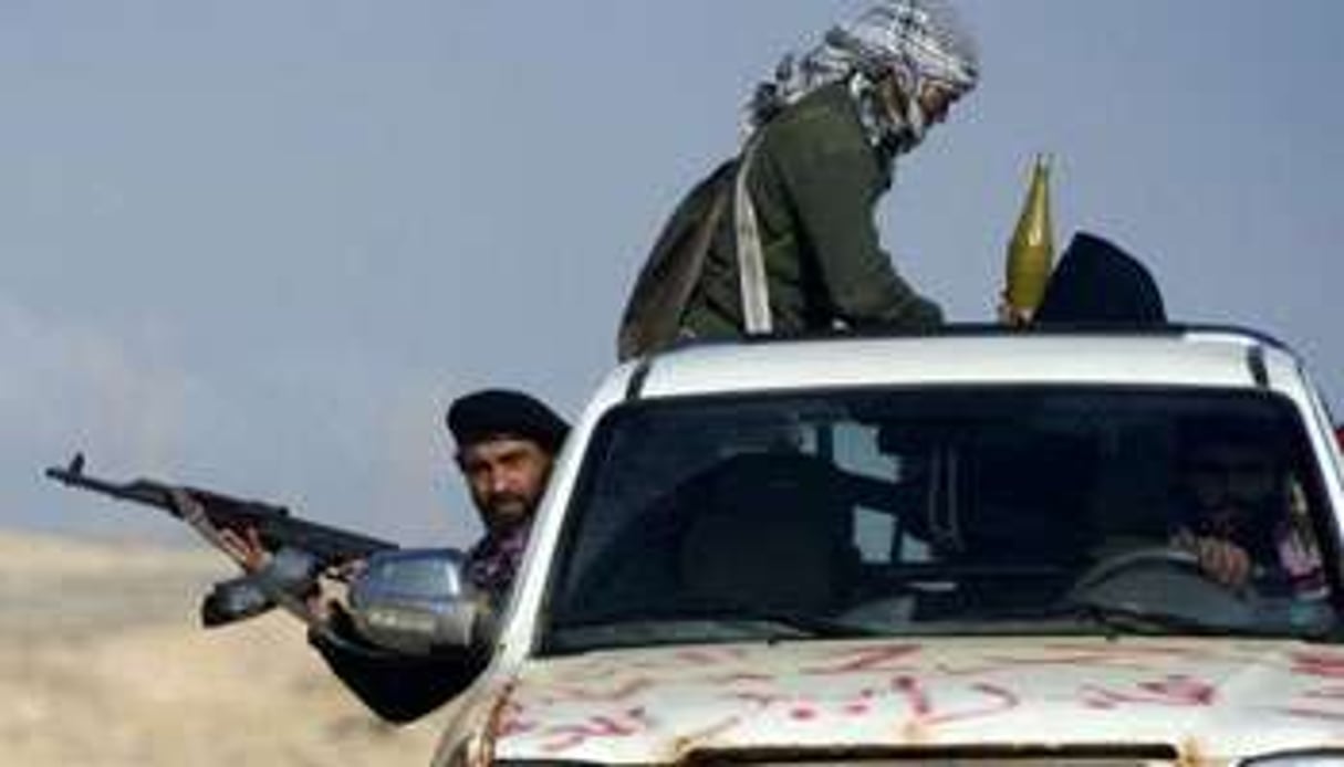 Des rebelles libyens à bord d’un pick-up près de Brega, le 5 avril 2011. © AFP