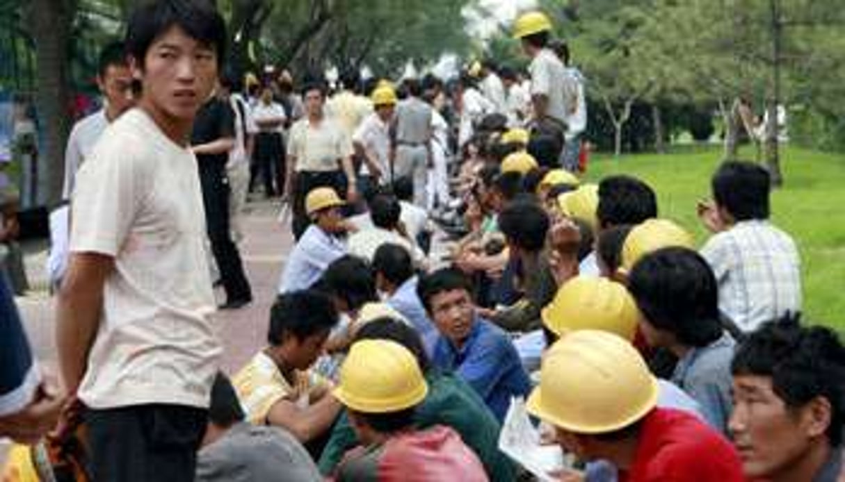 Manifestation d’ouvriers de la construction en 2007 à Beijing. © Teh Eng Koon/AFP