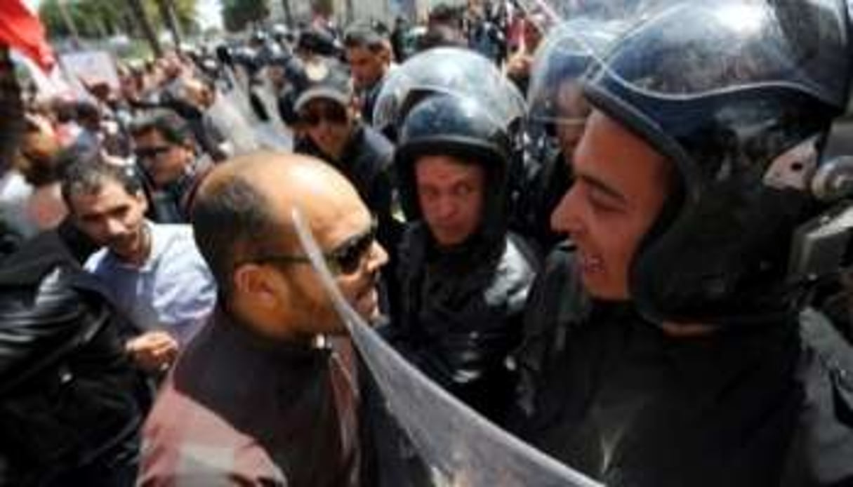 Un manifestant face à des policiers, à Tunis le 9 avril 2012. © AFP