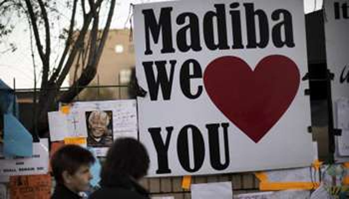 Des Sud-Africains portent des pancartes de soutien à Nelson Mandela, le 25 juin 2013 à Pretoria. © AFP