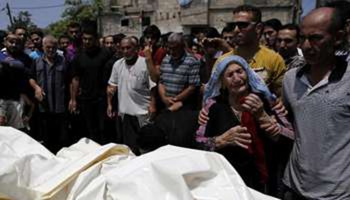 Funéraille de Palestiniens d’une même famille tués par des raids israéliens, le 22 juillet 2014. © AFP