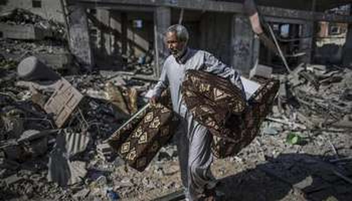 Un homme récupère des affaires dans les ruines du quartier de Chajaya, à Gaza, le 27 juillet. © Marco Longari/AFP