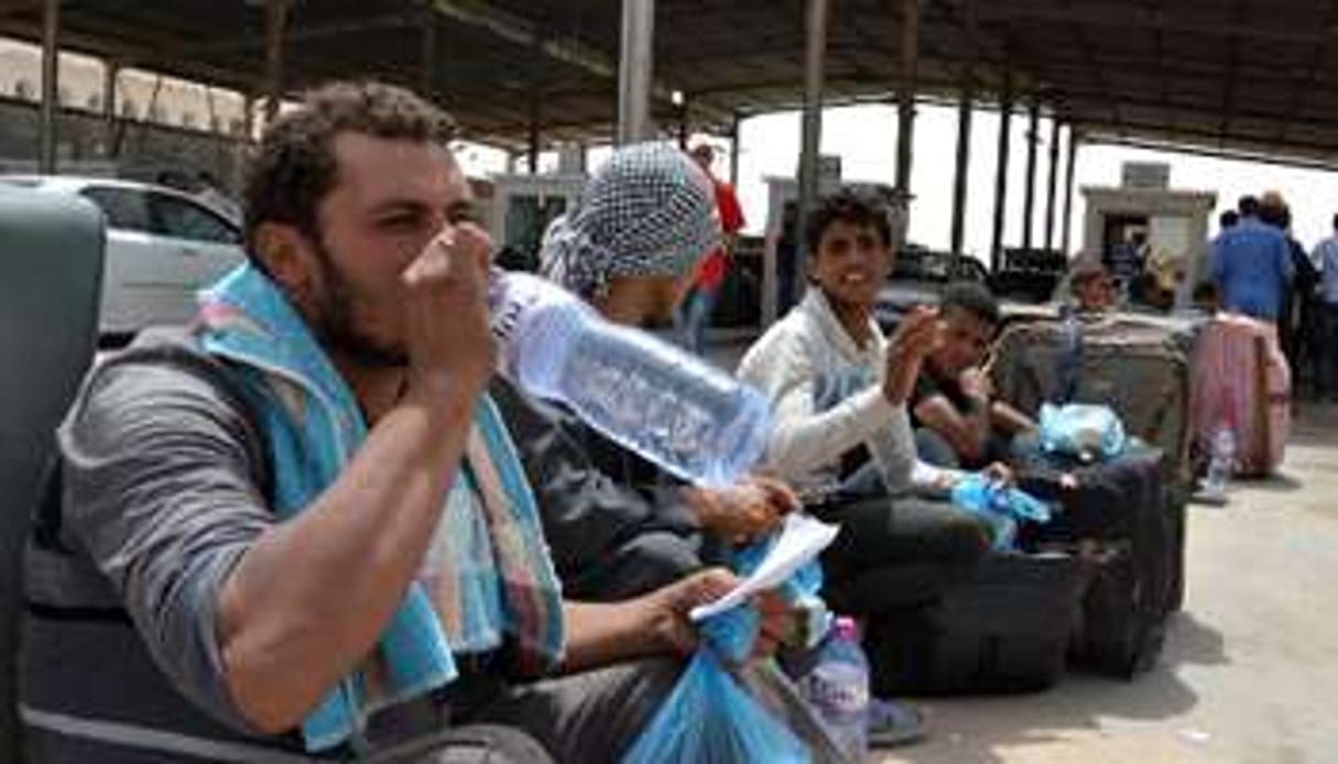 Des Egyptiens fuyant les violences en Libye au poste de frontière de Ras Jedir, le 3 août. © AFP