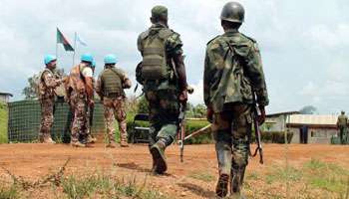 Des soldats de l’armée du RDC près de Casques bleus à Mavivi, le 22 octobre 2014. © AFP