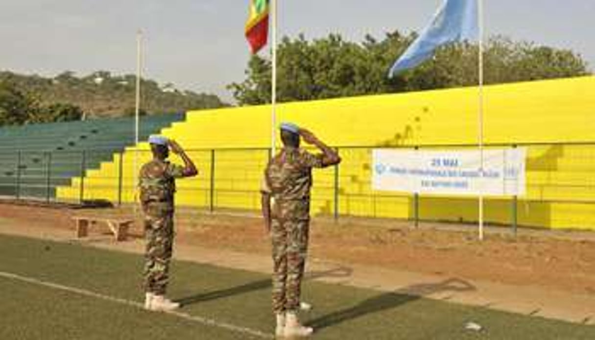 Des Casques bleus de la Minusma saluent les drapeaux malien et onusien à Bamako, 29 mai 2015. © Habibou Kouyate