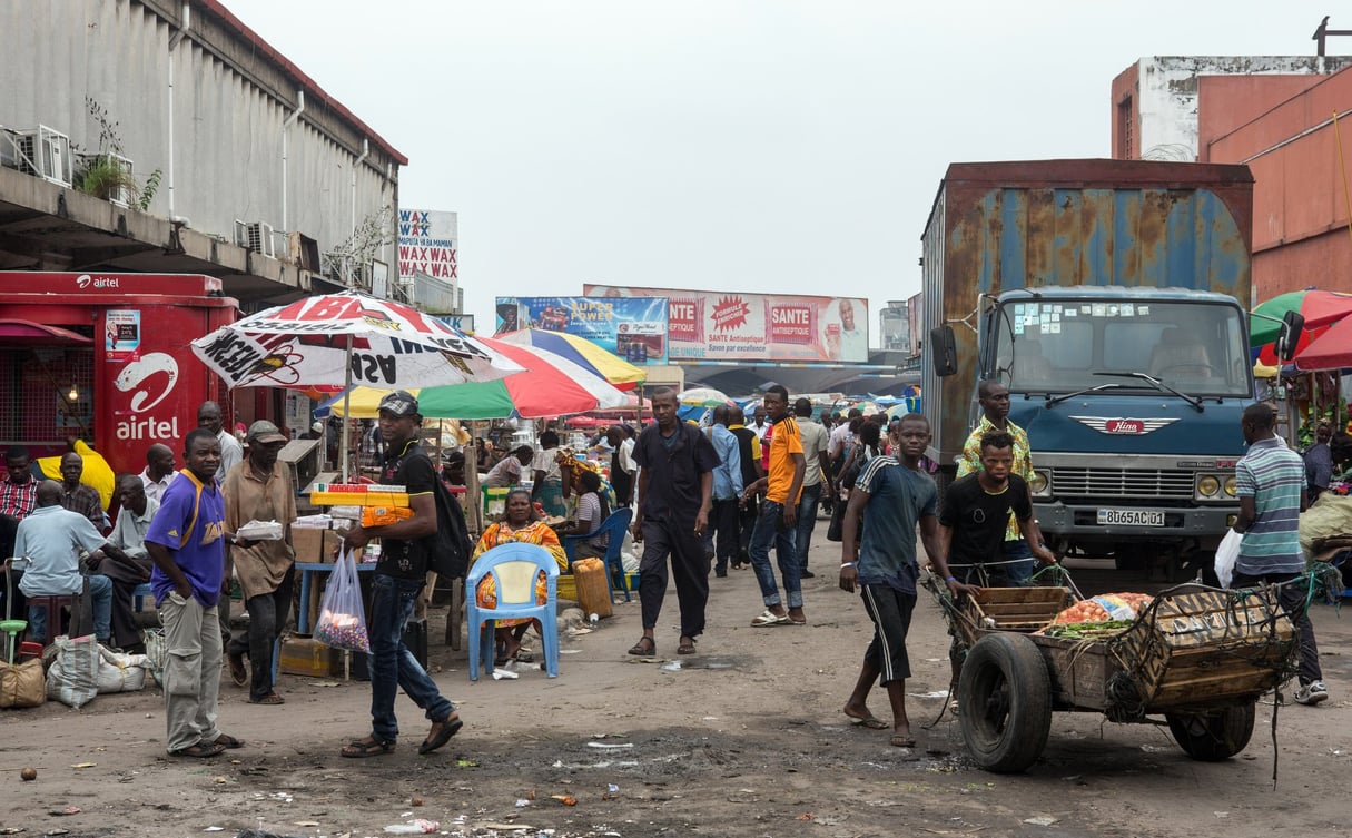 Scène quotidienne dans le quartier commerçant à proximité de l’avenue du Commerce et du grand marché de Kinshasa, le 14 octobre 2014. © Gwenn Dubourthoumieu / Jeune Afrique