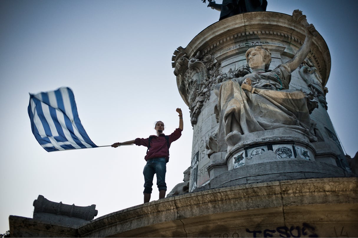 Drapeau grec brandi par un manisfestant d'extrême gauche, place de la République,à Paris, le 5 juillet. &copy; STÉPHANE LAGOUTTE/M.Y.O.P.