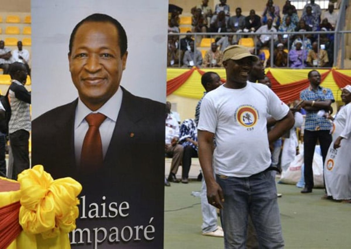 Un militant du CDP pose près d’une affiche de l’ancien président Blaise Compaoré, le 10 mai 2015 à Ouagadougou. © Ahmed Ouoba/AFP