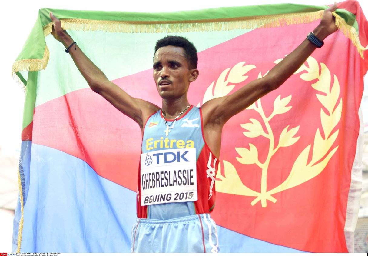 Ghirmay Ghebreslassie hoists Eritrea's flag after winning the men's marathon at the World Championships in Beijing on Aug. 22, 2015. The 19-year-old runner gave Eritrea its first World Championships gold medal. (Kyodo)==Kyodo Photo via Newscom/kyodowc141017/1508221020 &copy; NEWSCOM/SIPA