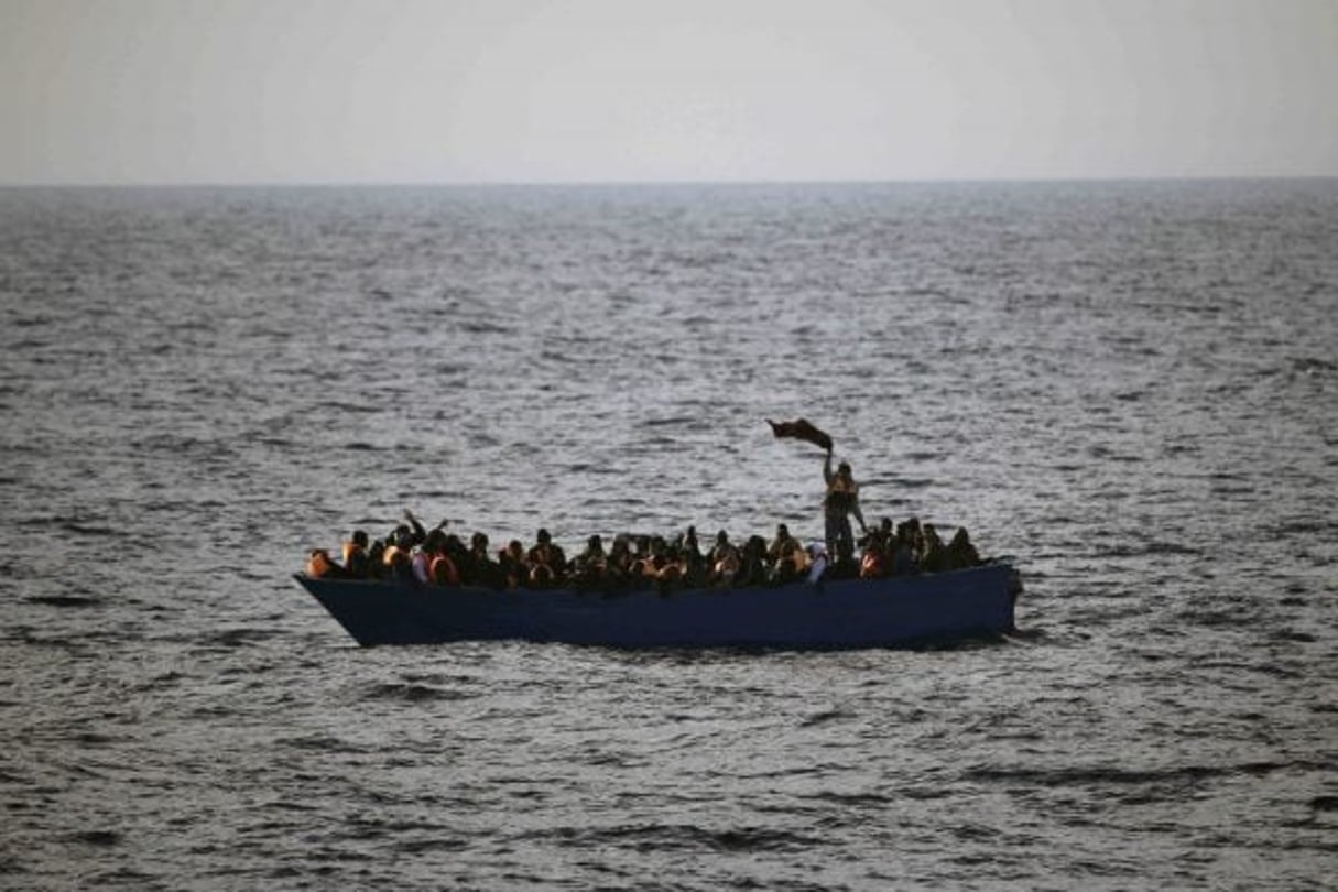 Des migrants appellent à l’aide depuis une embarcation au large de la Libye en février 2017. © Emilio Morenatti/AP/SIPA