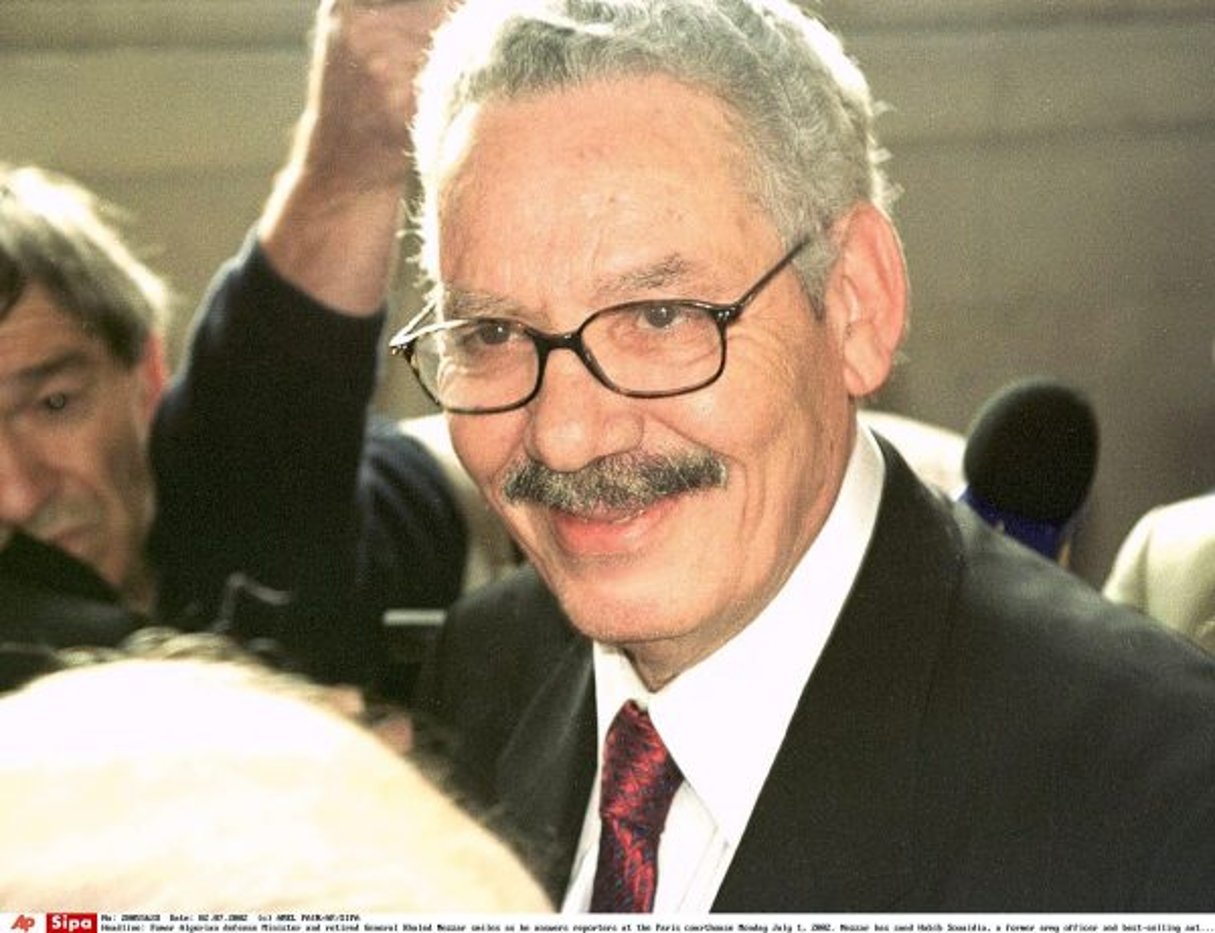 Fomer Algerian defense Minister and retired General Khaled Nezzar smiles as he answers reporters at the Paris courthouse Monday July 1, 2002. Nezzar has sued Habib Souaidia, a former army officer and best-selling author for defamation for linking him to atrocities in Algeria’s war on islamic extremists. The trial , expected to last a week, could provide a forum for those who claim the army stood by during massacres or even participated in them. (AP Photo/Amel Pain)/0207011935 © AMEL PAIN/AP/SIPA