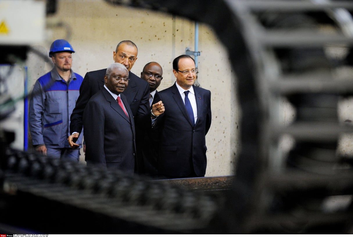 Au premier plan, l’ex-président Armando Guebuza et son homologue français de l’époque, François Hollande, à Cherbourg, en septembre 2013. Au second plan, Iskandar Safa, patron de Privinvest. © WITT/SIPA