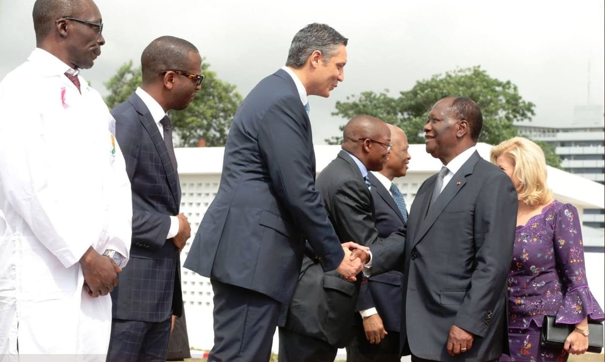 Poignée de main entre Adil Mesfioui, fondateur et PDG d’Agentis, et le président ivoirien, Alassane Ouattara, le 18 décembre 2017, suite à l’ouverture du premier centre de radiothérapie et d’oncologie du pays. © Présidence de Côte d’Ivoire (Twitter)