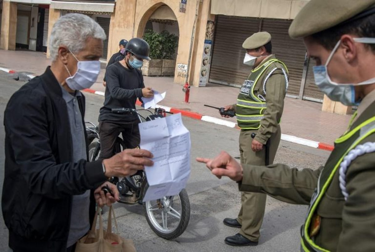 Des policiers contrôlent les personnes dans une rue de Rabat, le 9 avril 2020 au Maroc pendant l’épidémie de coronavirus. © FADEL SENNA/AFP