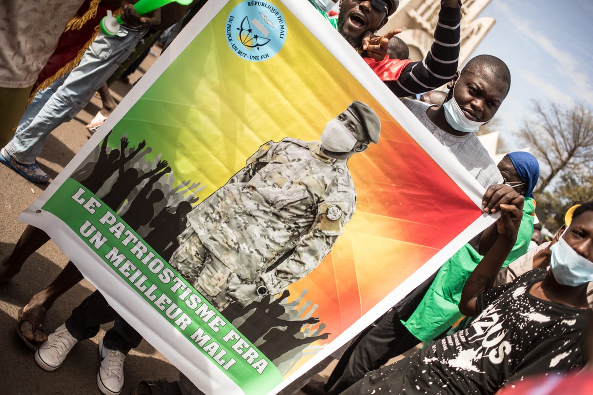 Un manifestant porte une affiche à l’image du président de la transition malienne, durant une manifestation contre la France et les sanctions de la Cedeao, à Bamako, le 14 janvier 2022. © Florent Vergnes