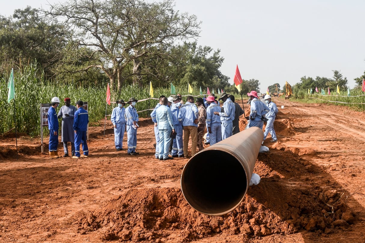 Des ouvriers nigériens et chinois sur le chantier de construction d’un oléoduc dans la région de Gaya, au Niger, le 10 octobre 2022. © BOUREIMA HAMA/AFP