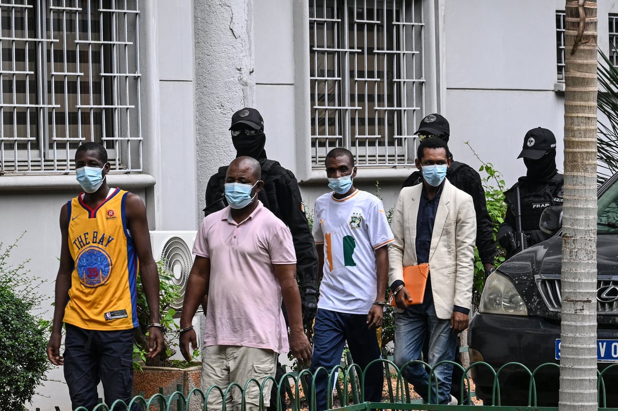 Les quatre accusés de l’attentat de Grand-Bassam arrivent escortés par des policiers ivoiriens à la cour d’appel du tribunal d’Abidjan, pour le verdict du procès en appel, où ils sont condamnés à la perpétuité, le 14 février 2025. © Sia KAMBOU / AFP