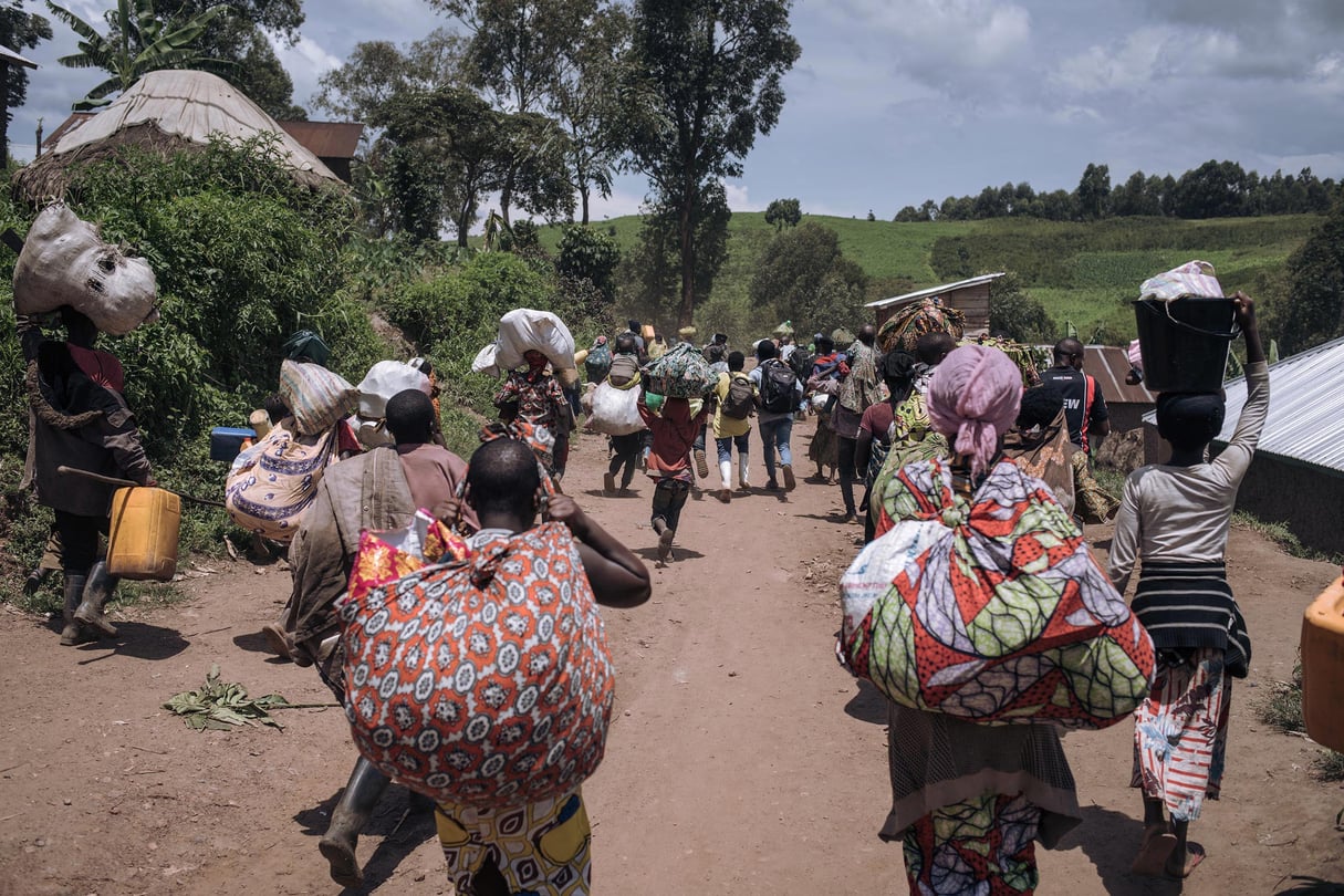 Des habitants de Bambo, à 60 kilomètres au nord de Goma, fuient lors de l’attaque de la ville par le M23, le 26 octobre 2023. © ALEXIS HUGUET/AFP