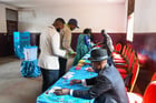 (251012) — YAOUNDE, Oct. 12, 2025 (Xinhua) — Voters get ballots at a polling station during the presidential election in Yaounde, Cameroon, Oct. 12, 2025. Voting for Cameroon's presidential election started early on Sunday as voters queued up outside polling stations across the country. According to the Cameroonian electoral body, Elections Cameroon (ELECAM), more than 8 million voters are set to cast their votes in over 31,000 polling stations.