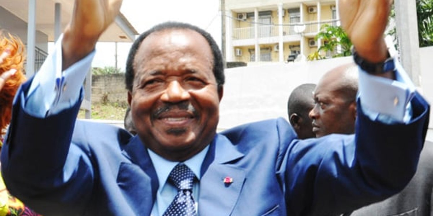 Paul Biya en compagnie de son épouse Chantal, saluent la population après avoir effectué le vote lors de l’élection présidentielle dans le bureau de vote de l’école publique du quartier de Bastos, à Yaoundé, au Cameroun, le 9 octobre 2011. © JA