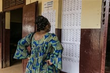 Une électrice camerounaise cherche son nom dans la liste des votants avant de participer au scrutin général et municipal, à Yaoundé, le 9 février 2020. © AFP