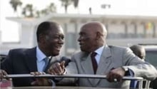 Wade et Ouattara sur le tarmac de l’aéroport de Dakar, le 12 mai 2011. © AP