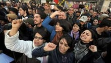 Des Tunisiens manifestent devant le siège du syndicat UGTT. © AFP