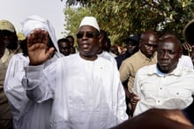 Le président sénégalais Macky Sall salue ses partisans après avoir voté pour la présidentielle à Fatick, le 24 février 2019. © SEYLLOU/AFP