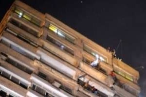 Des manifestants escaladent l’immeuble de l’ambassade d’Israël et jettent le drapeau israélien. © AFP