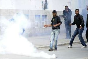 Des manifestants tunisiens reculent devant une bombe lacrymogène, le 7 avril 2012 à Tunis. © AFP
