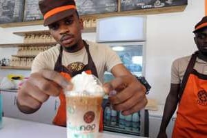 Un employé de la chaîne de café Neo prépare un café glacé à Lagos le 4 décembre 2014. © AFP