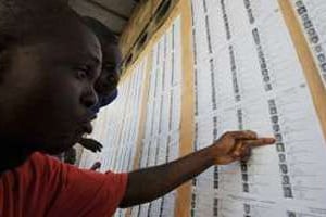 Des habitants d’Abidjan cherchent leur nom sur la liste électorale provisoire affichée. © Archives/AFP