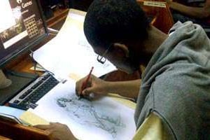Un graphiste au travail dans la « grotte », les locaux de la jeune entreprise à Yaoundé © Aurion