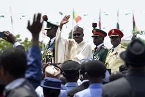 Le nouveau président du Nigeria Muhammadu Buhari (c) salue la foule après sa prestation de serment © AFP