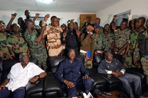 Le 7 janvier à Bouaké, après les négociations entre le ministre délégué à la Défense, Alain-Richard Donwahi (au centre), et une délégation de soldats. © Sia KAMBOU/AFP