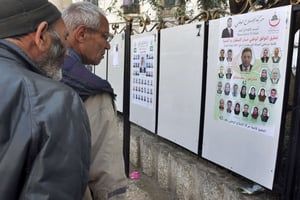 Des Algériens devant des affiches électorales le 9 avril 2017 à Alger. © Anis Belghoul/AP/SIPA