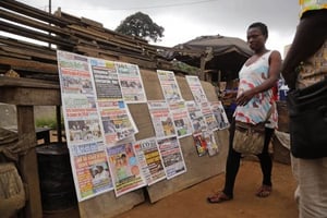Une femme devant un kiosque à journaux, le 26 octobre 2015 à Abidjan, en Côte d’Ivoire (photo d’illustration). © Schalk van Zuydam/AP/SIPA