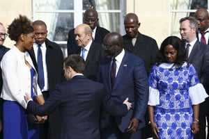 George Weah (au centre), président du Liberia, lors de sa visite à l’Élysée, à Paris. © Stephane Mahe/ Pool Photo via AP