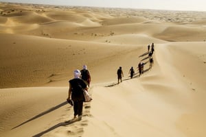 Trekking dans les dunes de l’erg Ouarane. © Michel Setboun/Corbis -Getty