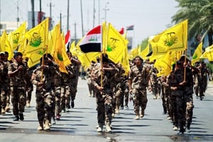 Défilé de la milice proche de l’Iran du Hashd al-Chaabi. Le logo du groupe reprend des éléments de celui du Hezbollah libanais. © Khalid al Mousily/REUTERS