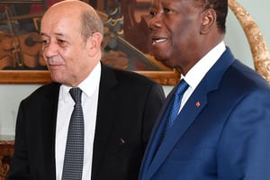 Jean-Yves Le Drian et Alassane Ouattara, en 2018. France’s Minister for Foreign Affairs Jean-Yves Le Drian (L) stands past Ivory Coast’s President Alassane Ouattara upon his arrival at the presidential palace in Abidjan on October 18, 2018. 
© ISSOUF SANOGO/AFP