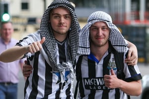 Des fans de Newcastle coiffés « à la saoudienne » le jour du rachat de leur club par le royaume, le 7 octobre 2021. © Michael Driver/MI News/NurPhoto via AFP