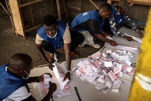 Des fonctionnaires électoraux comptent les votes après les élections générales dans un bureau de vote à Monrovia, le 10 octobre 2023. © JOHN WESSELS / AFP